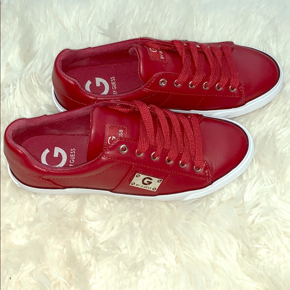 A pair of G by Guess Maroon leather sneakers